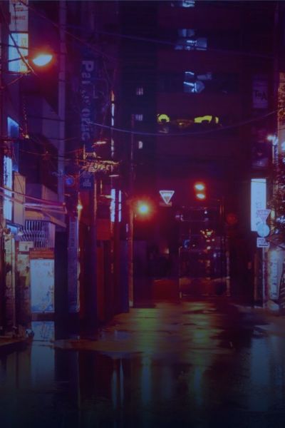 Neon-lit city street at night after rain