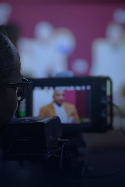 Television camera filming a live studio broadcast