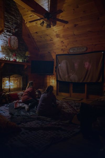 People watching a film together in a cosy living room